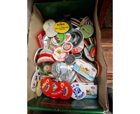 A box of vintage pin badges 