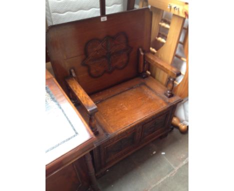 A carved oak monk's bench/table, width 76cm 