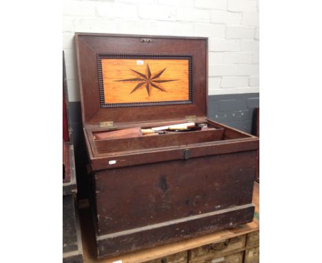 An antique joiner's toolbox with marquetry inlay to the interior containing a number of vintage woodworking/hand tools, saws,