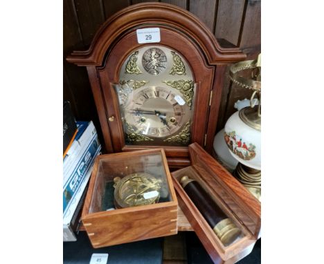 A 31 day mantle clock with key, a reproduction brass compass in wood/glass case, and a reproduction three draw telescope in a