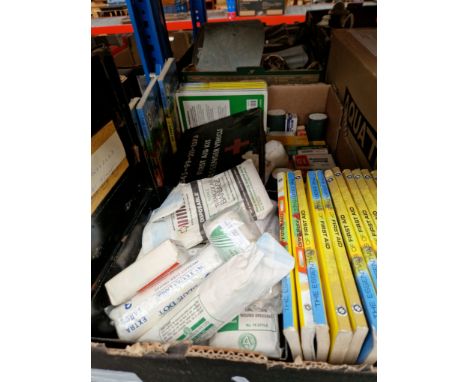 A box containing first aid boxes and St Johns Ambulance books. 