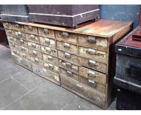 A vintage bank of 33 drawers, length 214cm. Condition- various surface marks throughout including oil and paint, two or three