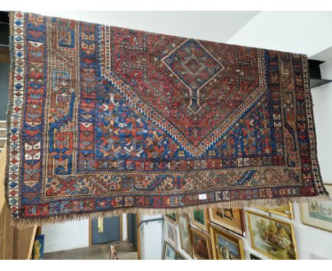 A vintage Middle Eastern hand knotted wool carpet, blue ground, 190cm x 160cm (approx).Condition:- General wear through age a