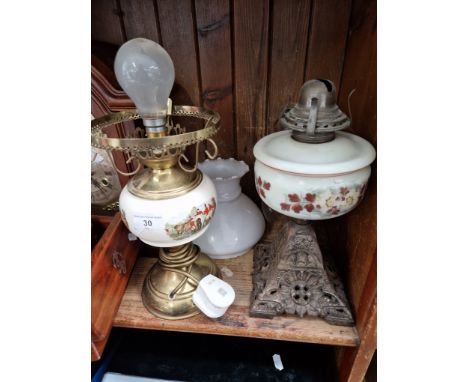 An oil lamp with cast base, glass bowl and funnel, and a brass electric table lamp in the form of an oil lamp with glass shad