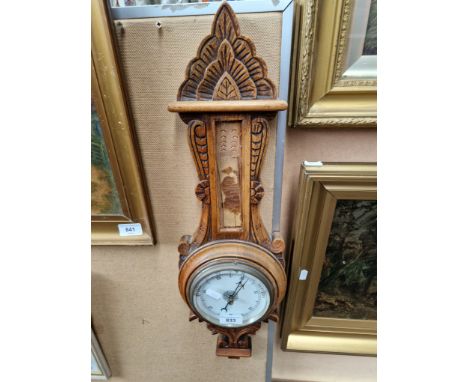 An oak cased barometer (thermometer missing). 