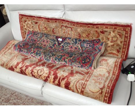 Two vintage eastern wool carpets, one cream and red (190cm x 124cm approx), the other blue and pink (130cm x 88cm approx). 