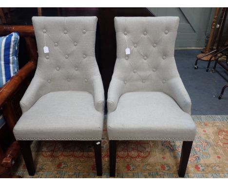 A PAIR OF CONTEMPORARY UPHOLSTERED CHAIRS with buttoned backs and metal ring handles to the rear
