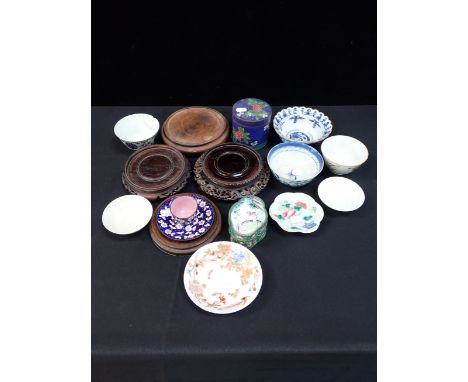 A COLLECTION OF ASIAN BOWLS AND SAUCERS with three cloisonne wares and Chinese hard wood stands