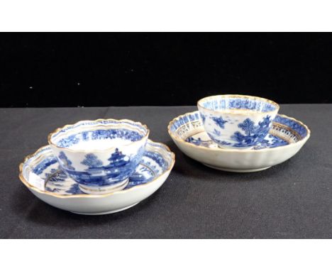 TWO EARLY 19TH CENTURY TEABOWLS AND SAUCERS (one cup and saucer non-matching) painted in underglaze blue with gilt rims