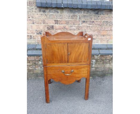 A GEORGE III MAHOGANY NIGHT COMMODE th top with handle cut-outs, with two doors and a single (converted) drawer under, on squ