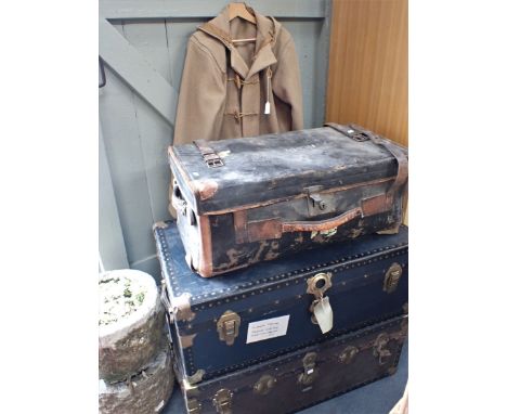 THREE VINTAGE TRAVELLING TRUNKS the largest 91cm wide, together with a duffle coat (moth damaged)