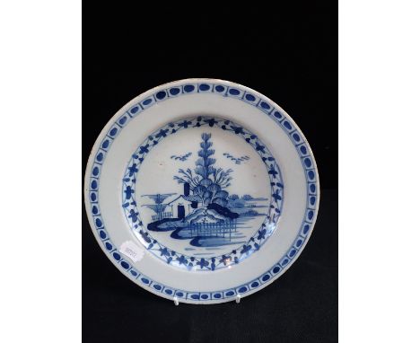 A DELFTWARE PLATE painted with a Chinese landscape, 23cm diam