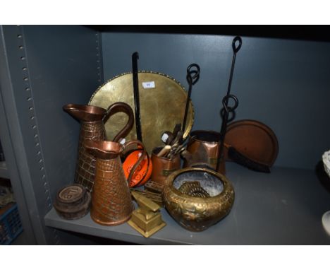 A selection of metal wares including enamel ladle, copper jugs, brass anvil, and copper cider measures.