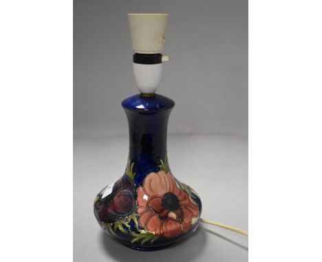 A vintage Moorcroft pottery lamp base having deep blue glaze on anemone
Slight rubbing/ glaze imperfection to tubelining in p
