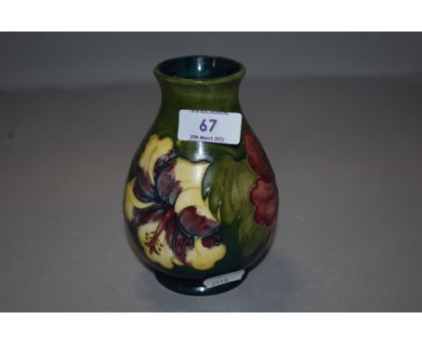 A vintage Moorcroft vase having green hue ground with anemone design
Good condition,nothing to note.