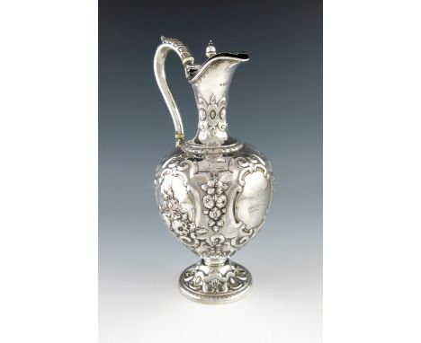 λA Victorian silver ewer, by Martin, Hall and Company, Sheffield 1866, baluster form, embossed foliate scroll decoration, eng