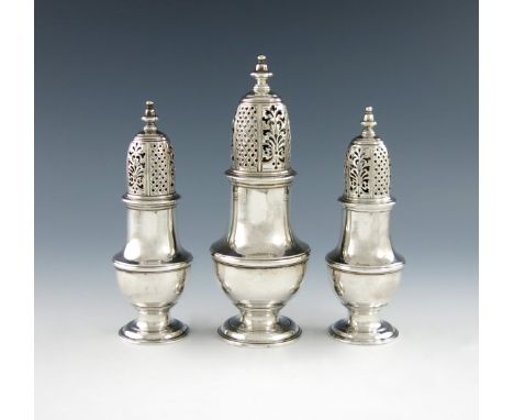 A suite of three George II silver sugar casters, by Samuel Wood, London 1746, baluster form, the pull-off pierced cover with 