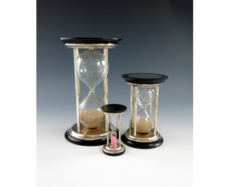 A suite of three modern silver timers, by Barker Ellis, Birmingham 2000-01, wooden bases, comprising: an hour glass, another 