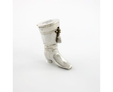 A French novelty silver vesta case, maker's mark of E.L in a lozenge, modelled as a boot, the hinged cover initialled, the in