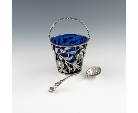 A George III silver swing-handled cream pail, possibly by T.L, London 1769, tapering circular form, pierced and embossed foli