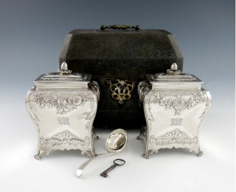 A pair of George III silver tea caddies, by Smith and Sharp, London 1762, rectangular bombι form, embossed foliate scroll dec