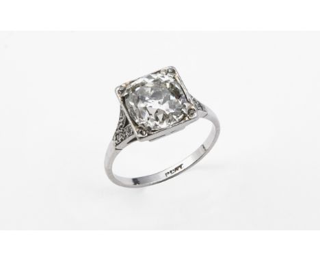 A DIAMOND SOLITAIRE RING set with a cushion-shaped diamond weighing approximately 3.05 carats, with five circular-cut diamond