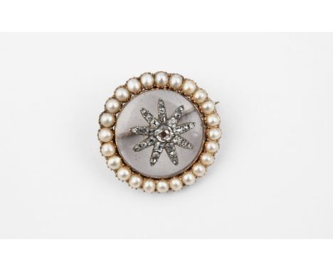 A VICTORIAN CRYSTAL, DIAMOND AND PEARL BROOCH of circular form, the crystal centre mounted with a diamond set flowerhead with