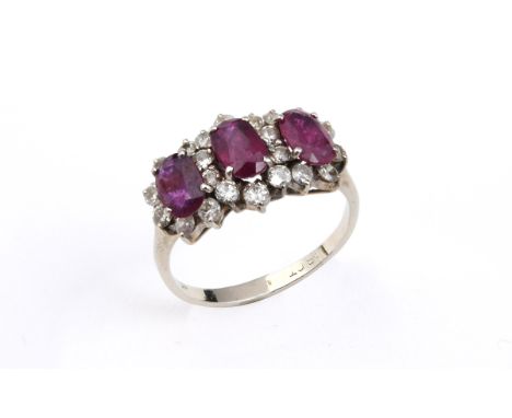 A RUBY AND DIAMOND TRIPLE CLUSTER RING the three oval-shaped rubies are each set within a surround of circular-cut diamonds, 
