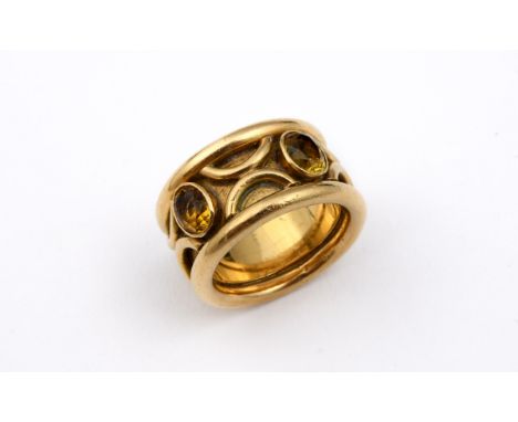 A GOLD AND GEM SET RING the gold band ring is mounted with two oval-shaped citrines, with embossed decoration, 18.8 grams. Si