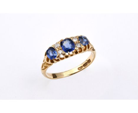 A SAPPHIRE AND DIAMOND RING the three oval-shaped sapphires are set with four circular old-cut diamonds, in 18ct gold. Size R