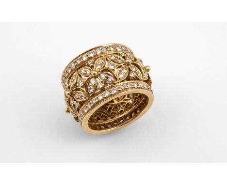 A DIAMOND AND GOLD FOLIATE BAND RING the openwork foliate design is set overall with circular-cut diamonds in yellow gold. Si