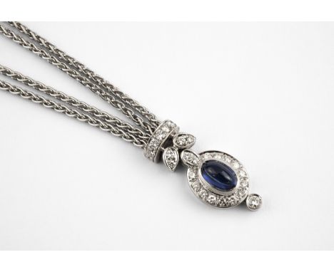 A SAPPHIRE AND DIAMOND CLUSTER PENDANT the oval cabochon sapphire is set within a surround circular-cut diamonds, with furthe