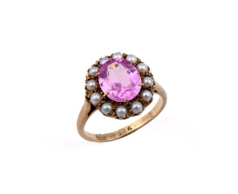 A PINK SAPPHIRE AND PEARL CLUSTER RING the oval-shaped pink sapphire is set within a surround of half pearls, in yellow gold.