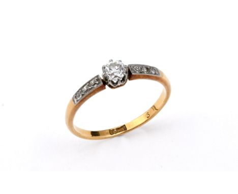 A DIAMOND SOLITAIRE RING the circular old-cut diamond is set with three circular-cut diamonds to each shoulder, in 18ct gold.