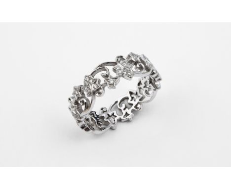 A DIAMOND ETERNITY RING of openwork foliate form, mounted with circular-cut diamonds, in 18ct white gold. Size R