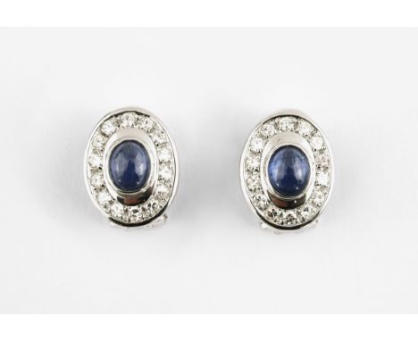 A PAIR OF SAPPHIRE AND DIAMOND CLUSTER CLIP EARRINGS each earring set with an oval-shaped cabochon sapphire within a surround