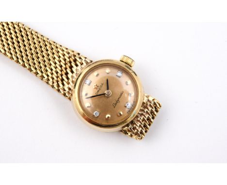 A LADY'S 18CT GOLD WRISTWATCH BY OMEGA the signed circular gold coloured dial with diamond quarters and dot numerals, on an i