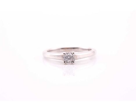 A single stone diamond ring; the round brilliant cut diamond in 9 carat white gold mount with 'Forever' diamond inset to the 