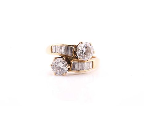 A yellow metal stamped 18ct diamond set ring, consisting of two claw set with round brilliant cut diamonds measuring 6.0mm an