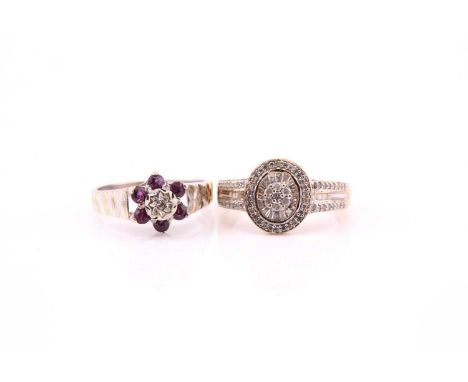 A multi-diamond, oval cluster ring; the central oval plaque and three row shoulders set with round brilliant, baguette and st