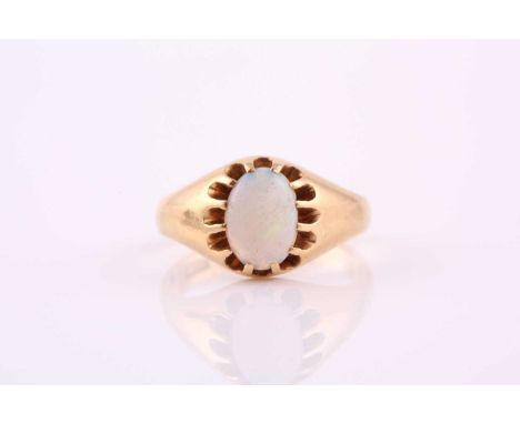 A single stone opal ring; the oval opal in carved claw mount, within a tapering band marked '18ct'. Ring size J; 5.2 gramsCon