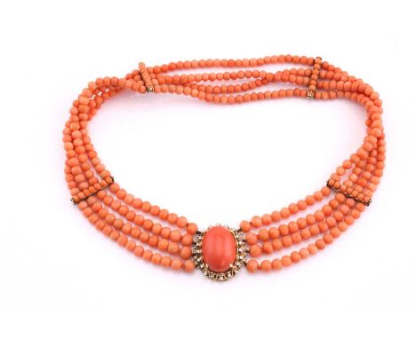 A four row coral bead necklace, with four yellow spacer bars, the clasp centred by a 25 x 18mm coral cabochon, to a yellow sc