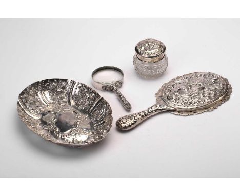 A Victorian silver bowl, a dressing table hand mirror, a cut glass bowl with silver cover and a magnifying glass, the oval bo