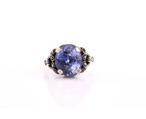 An oval sapphire single stone dress ring, consisting of an oval sapphire measuring 12.34x10.34mm claw set into silver with in