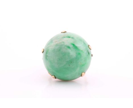 A large jade cabochon dress ring, modern, claw set to a yellow mount and wirework shank, stamped ‘14k’, cabochon 25mm diamete