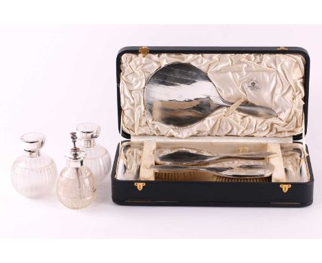 A cased five-piece Mappin &amp; Webb silver dressing set, Birmingham 1926. Together with two silver topped "Grenade" form per