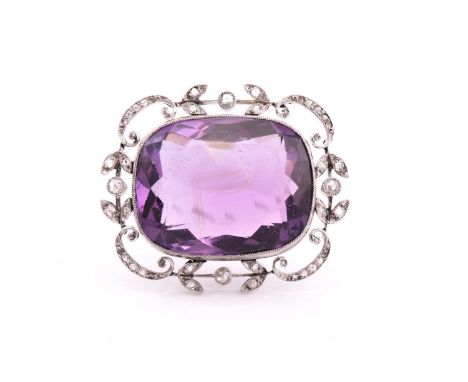 An Edwardian amethyst and rose-cut diamond brooch, consisting of a large cushion antique cut amethyst measuring approximately
