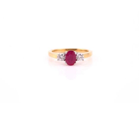 A ruby and diamond three stone half hoop ring; the central oval cut ruby in claw mount and flanked with round brilliant cut d