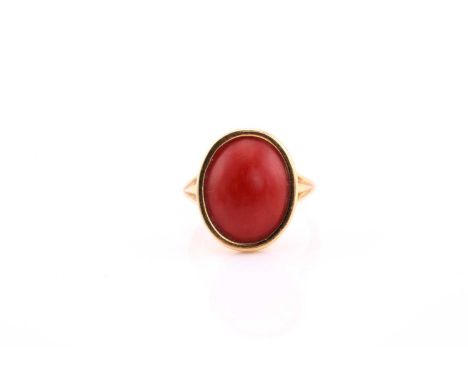 Red coral ring, modern, the oval coral cabochon rubover set to a yellow mount and simple shank with split shoulders, coral 16