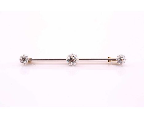 A three-stone old cut diamond set bar brooch, set with three round old cut diamonds with the central stone with an estimated 